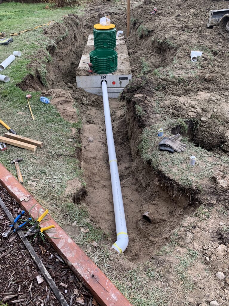 Robitaille Contracting technician repairing a septic system at a rural property in Nipissing, Ontario