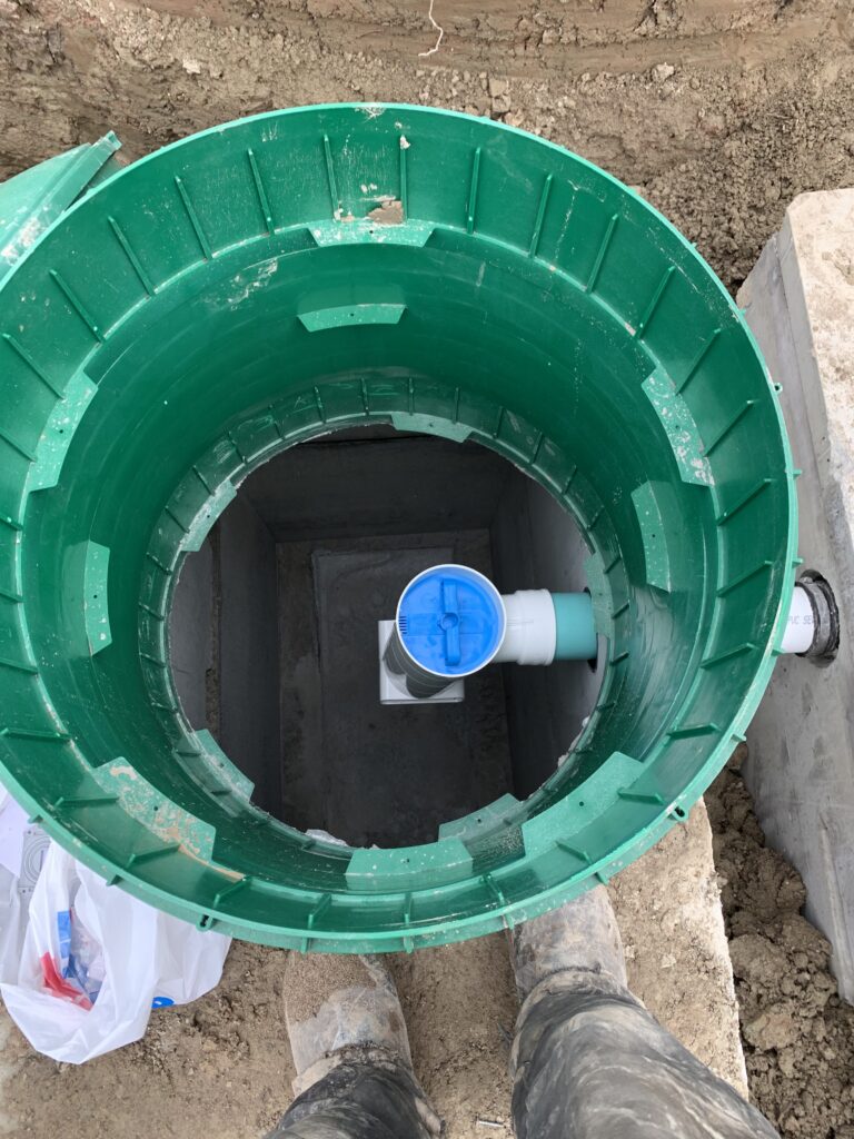 Robitaille Contracting technician performing septic tank pumping at a residential property in Trout Creek, Astorville, or North Bay