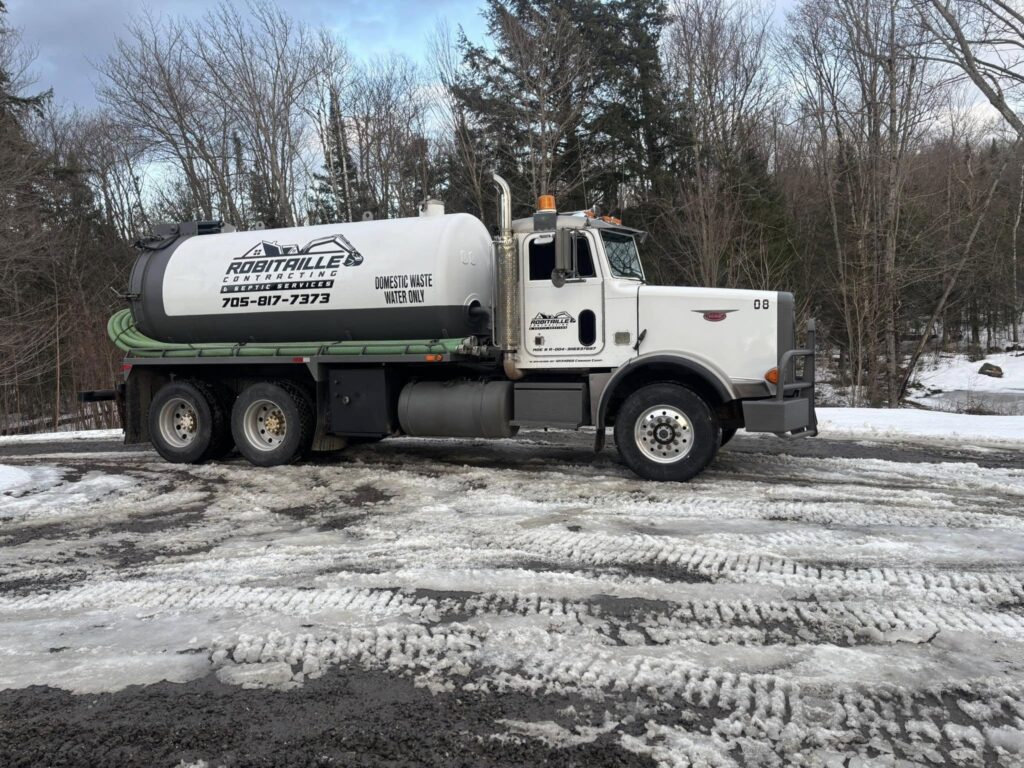Robitaille Contracting technician repairing a septic system at a residential property in Trout Creek, Astorville, or North Bay